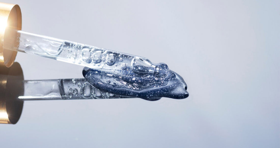 Close-up image of hyaluronic acid serum spilling from a dropper, symbolizing deep skin hydration and revitalization.